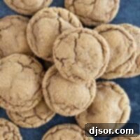 Pile of soft ginger cookies on a blue background.