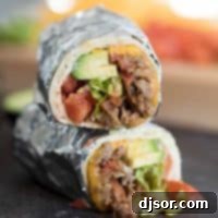 Hearty Bean Sausage and Beef Burrito 2 Bean, Sausage and Beef Burrito Recipe cut in half.