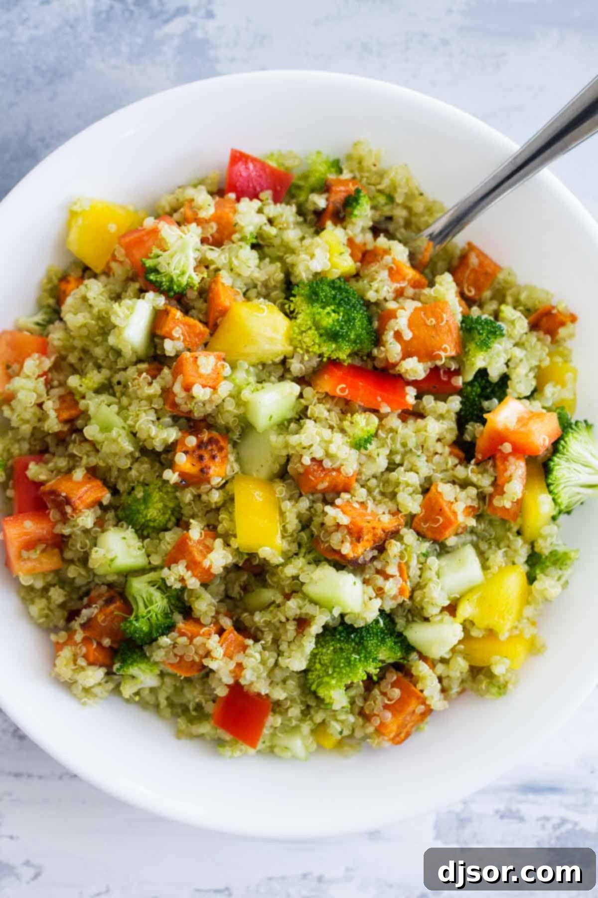 A vibrant bowl of Quinoa and Roasted Sweet Potato Salad, showcasing its healthy ingredients and colorful presentation.