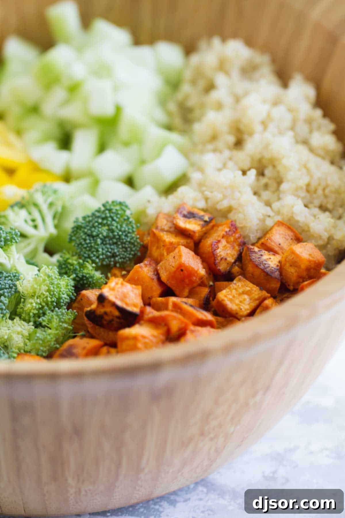 A close-up of the delicious Roasted Sweet Potato Salad with quinoa and colorful vegetables.