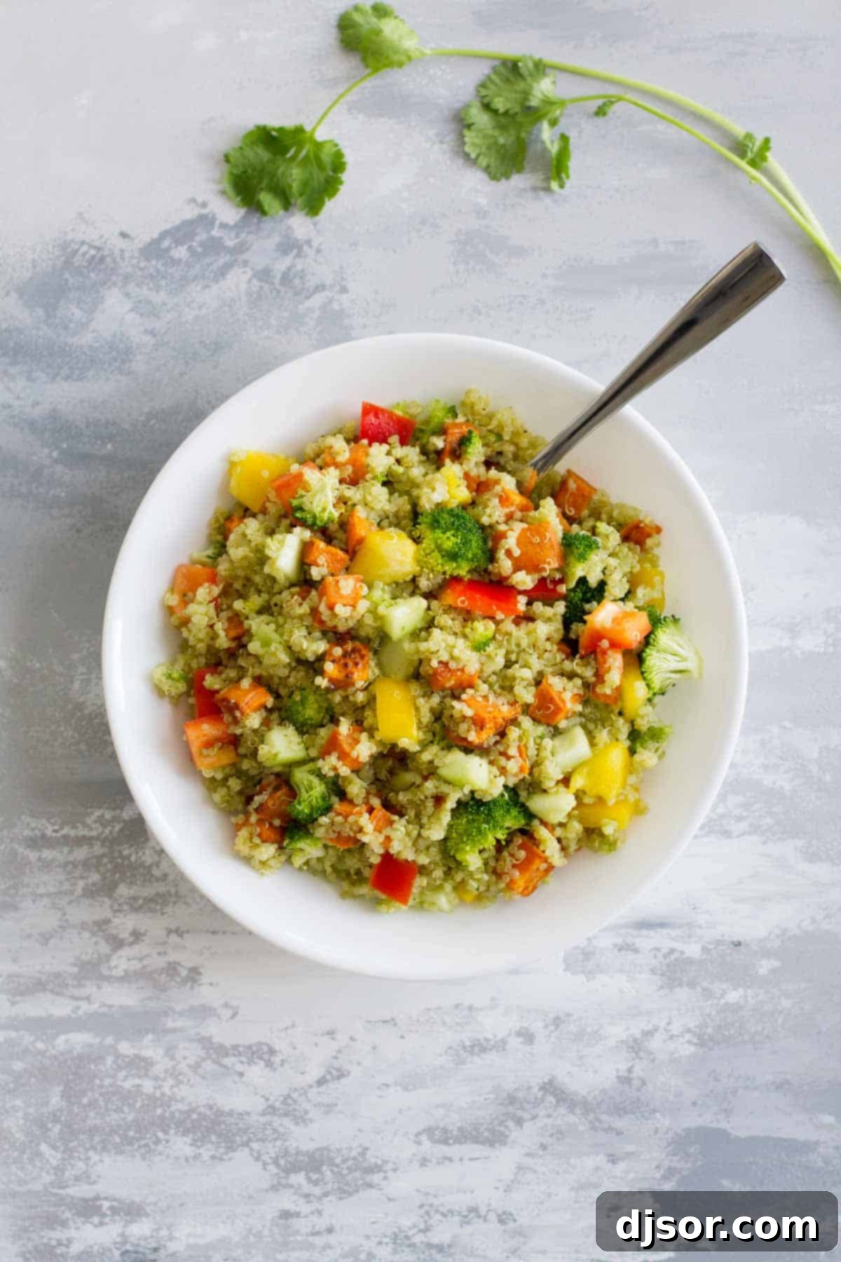 A large bowl filled with Quinoa and Roasted Sweet Potato Salad, ready to be served as a healthy and satisfying meal.