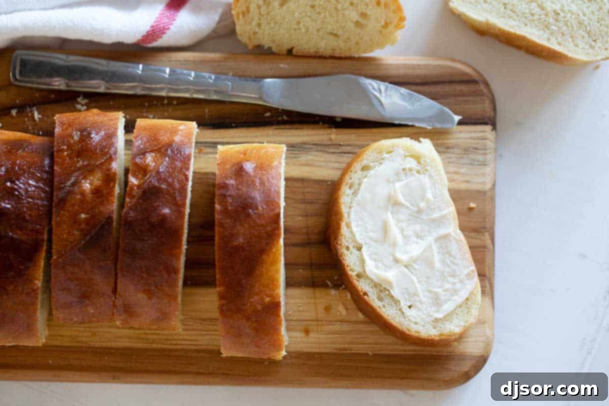 Sliced Homemade French Bread with Butter Freshly baked French Bread, sliced and ready to serve with butter