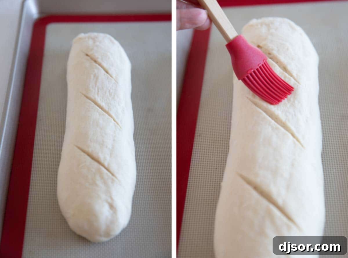 Pre-Bake Preparation: Scoring and Water Wash Close-up of scoring the top of a French bread loaf and brushing it with water before baking