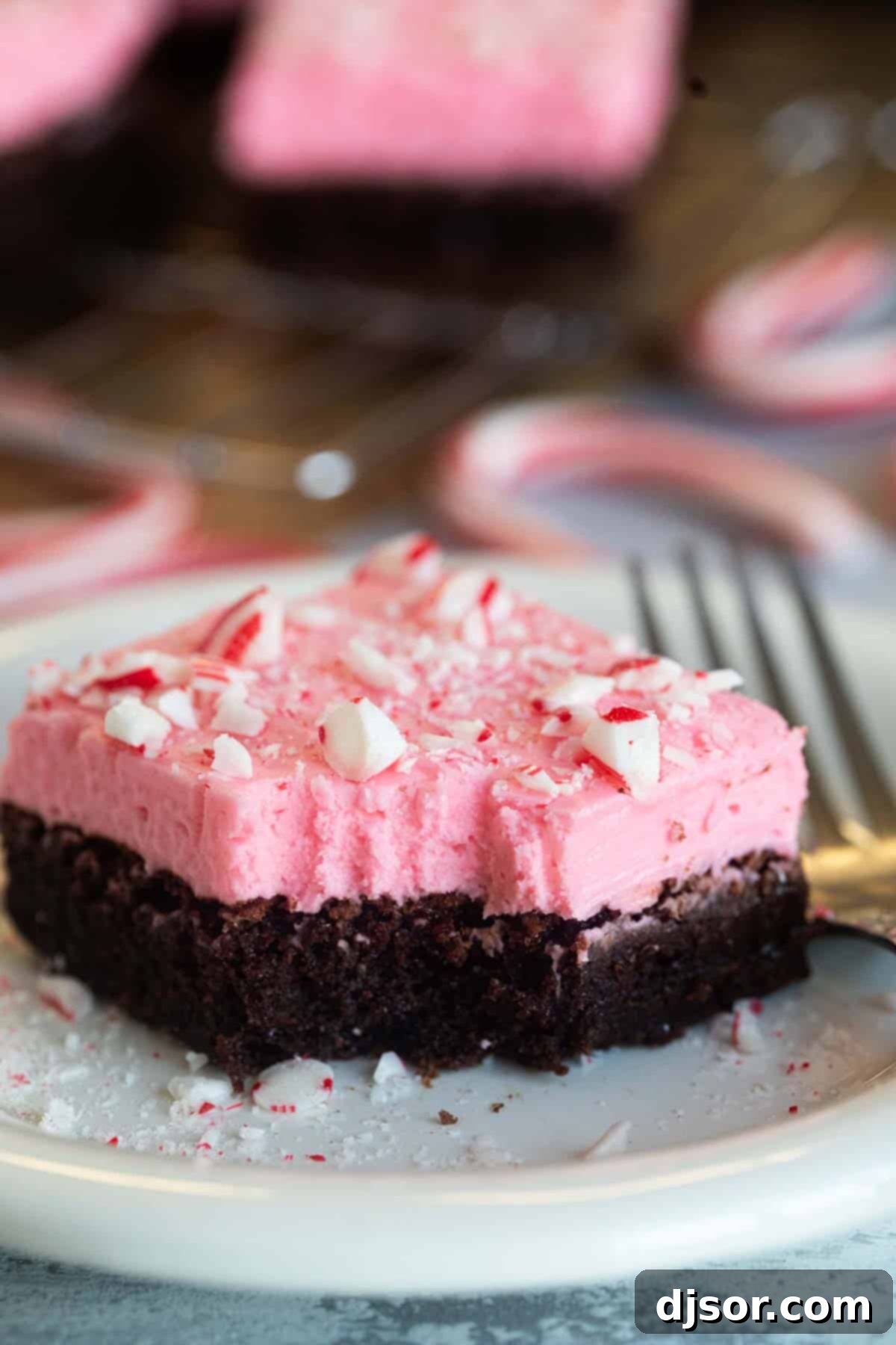 Chocolate Peppermint Dream 9 A delicious peppermint brownie with a bite taken out, revealing its rich fudgy interior and creamy, minty frosting.