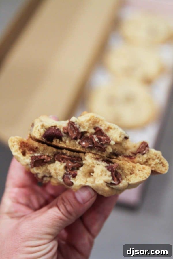 A close-up of a warm, gooey chocolate chip cookie from Crumbl.