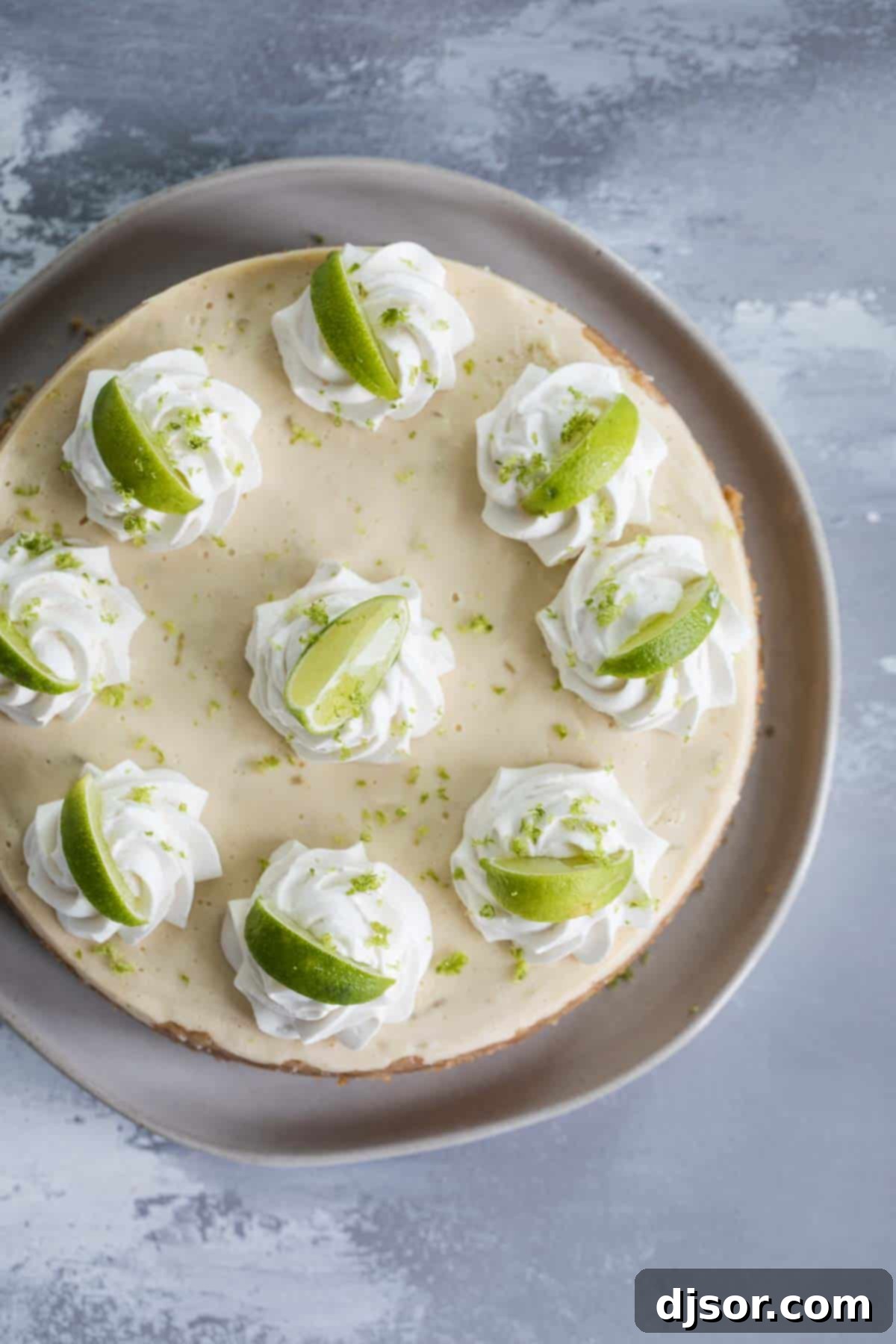Garnished Instant Pot Key Lime Cheesecake Creamy Pressure Cooker Key Lime Cheesecake topped with whipped cream and fresh lime slices