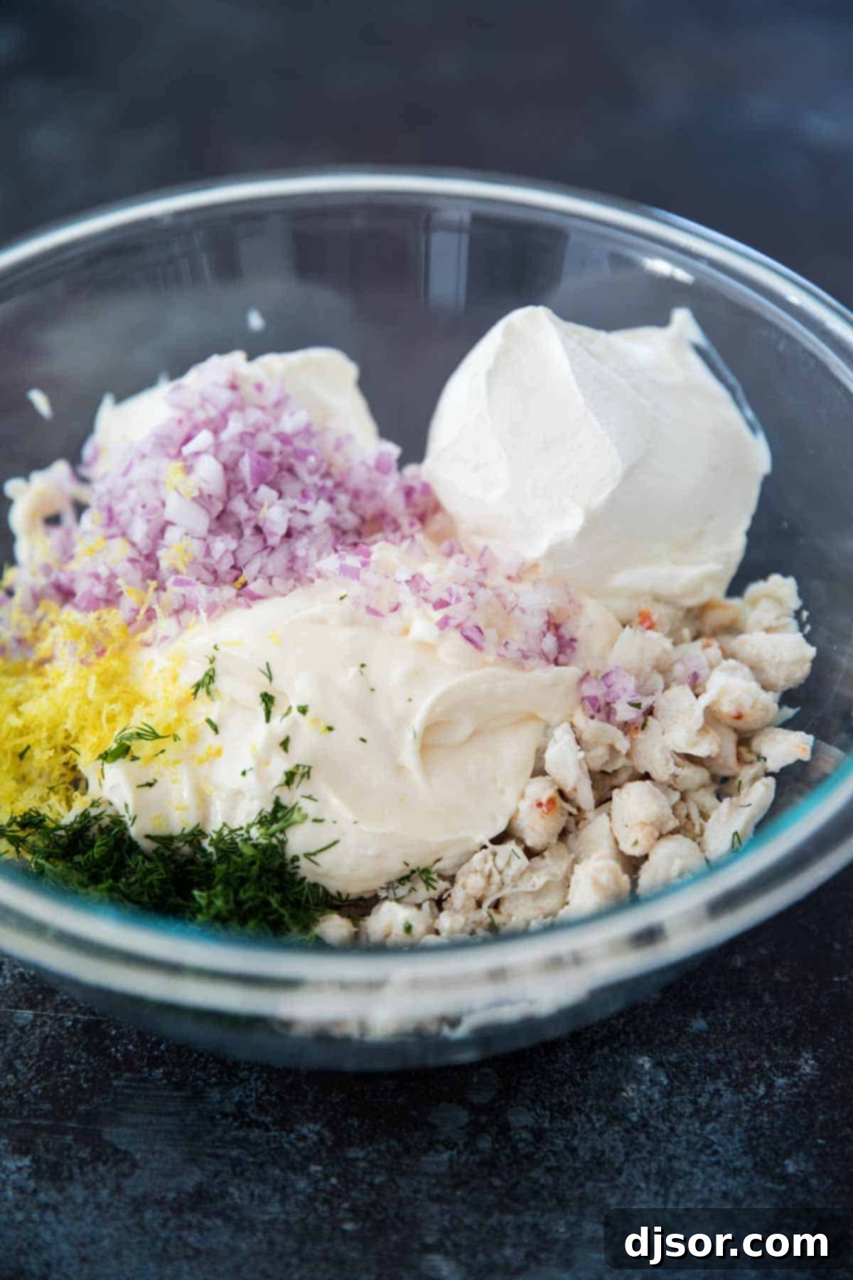 Simple ingredients for the best crab dip Ingredients for Easy Crab Dip laid out on a cutting board.