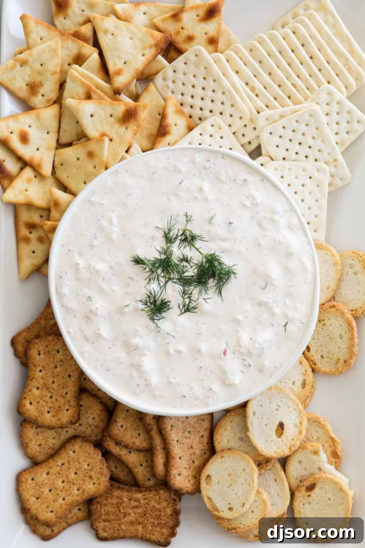 Perfectly paired: Easy Crab Dip and crispy crackers Easy Crab Dip Recipe served beautifully with a variety of crackers on a platter.