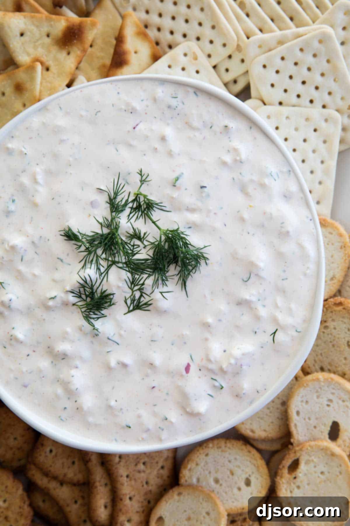 Serve this refreshing cold crab dip with your favorite dippers Cold Crab Dip Recipe surrounded by various crackers and fresh ingredients, ready for serving.