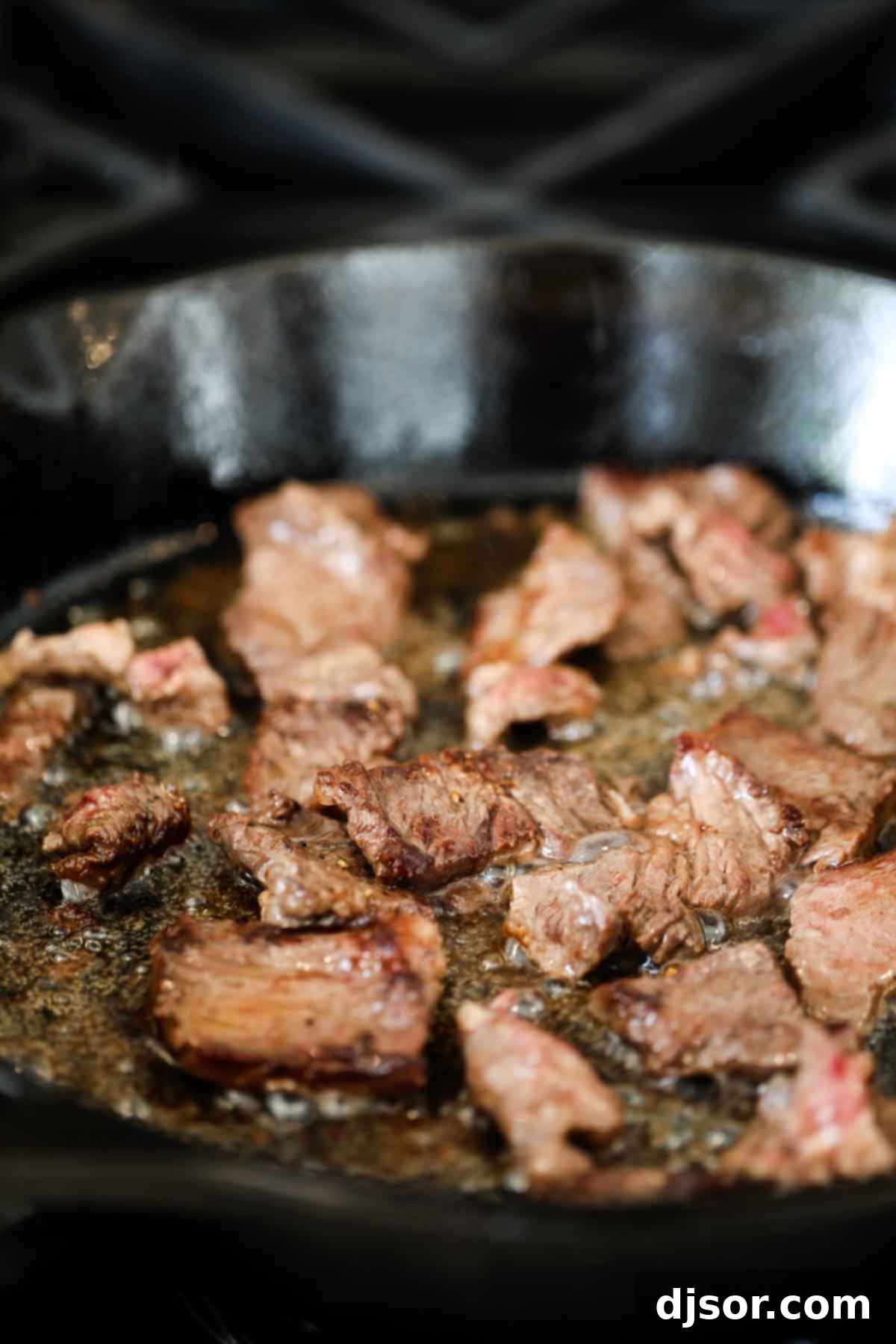 A classic comfort meal, this Beef Tips and Gravy cooks pieces of beef in a homemade gravy until it is super tender and flavorful. Serve over mashed potatoes, rice or noodles for the perfect Sunday supper that the whole family will go crazy over. beef tips cooking in a cast iron pan