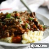 Homestyle Beef Tips in Gravy 2 beef tips and gravy over mashed potatoes on a plate