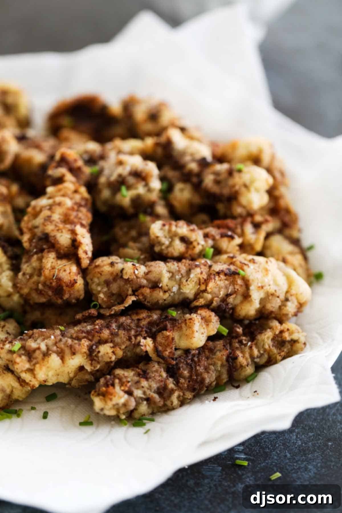 Chicken Fried Steak Fingers sprinkled with herbs, ready to be served.