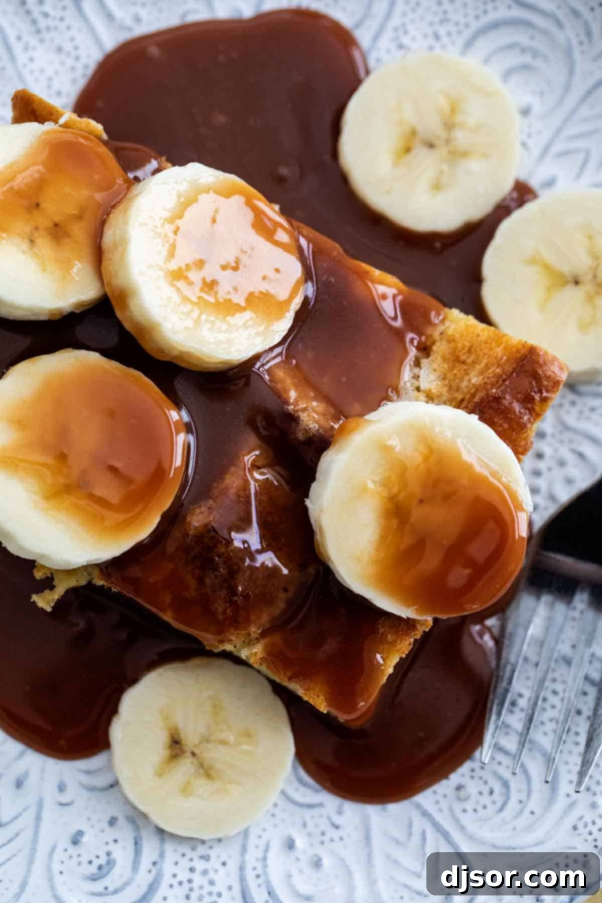Perfectly Topped Brioche French Toast Close up of Brioche French Toast with Salted Caramel and Bananas, showing the fluffy texture and decadent toppings.