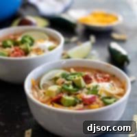 bowl of creamy chicken tortilla soup with lots of toppings