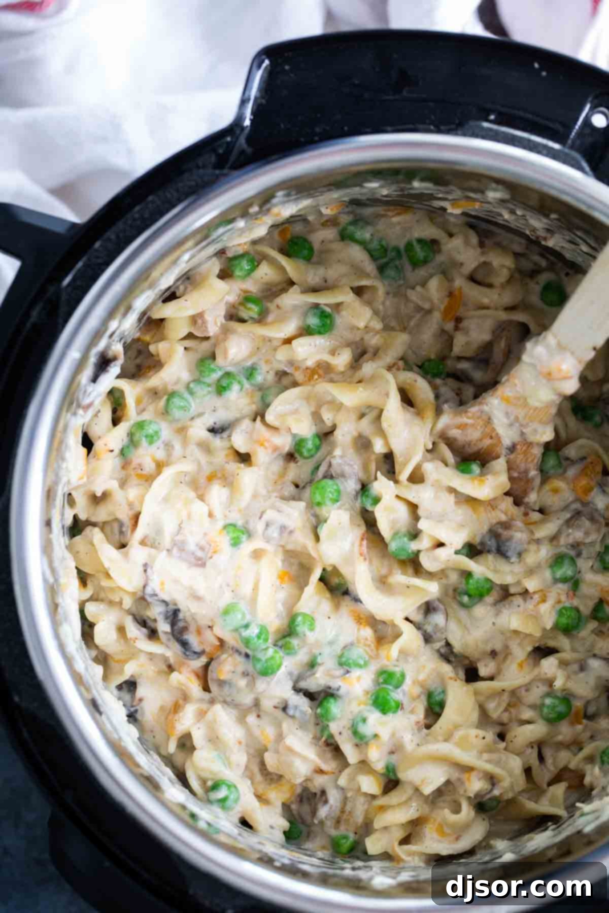 Creamy, cheesy and always comforting, this Instant Pot Tuna Noodle Casserole is so easy you’ll never bake it again. And bonus - this recipe is made from scratch! Homemade Tuna Noodle Casserole being stirred in an Instant Pot.