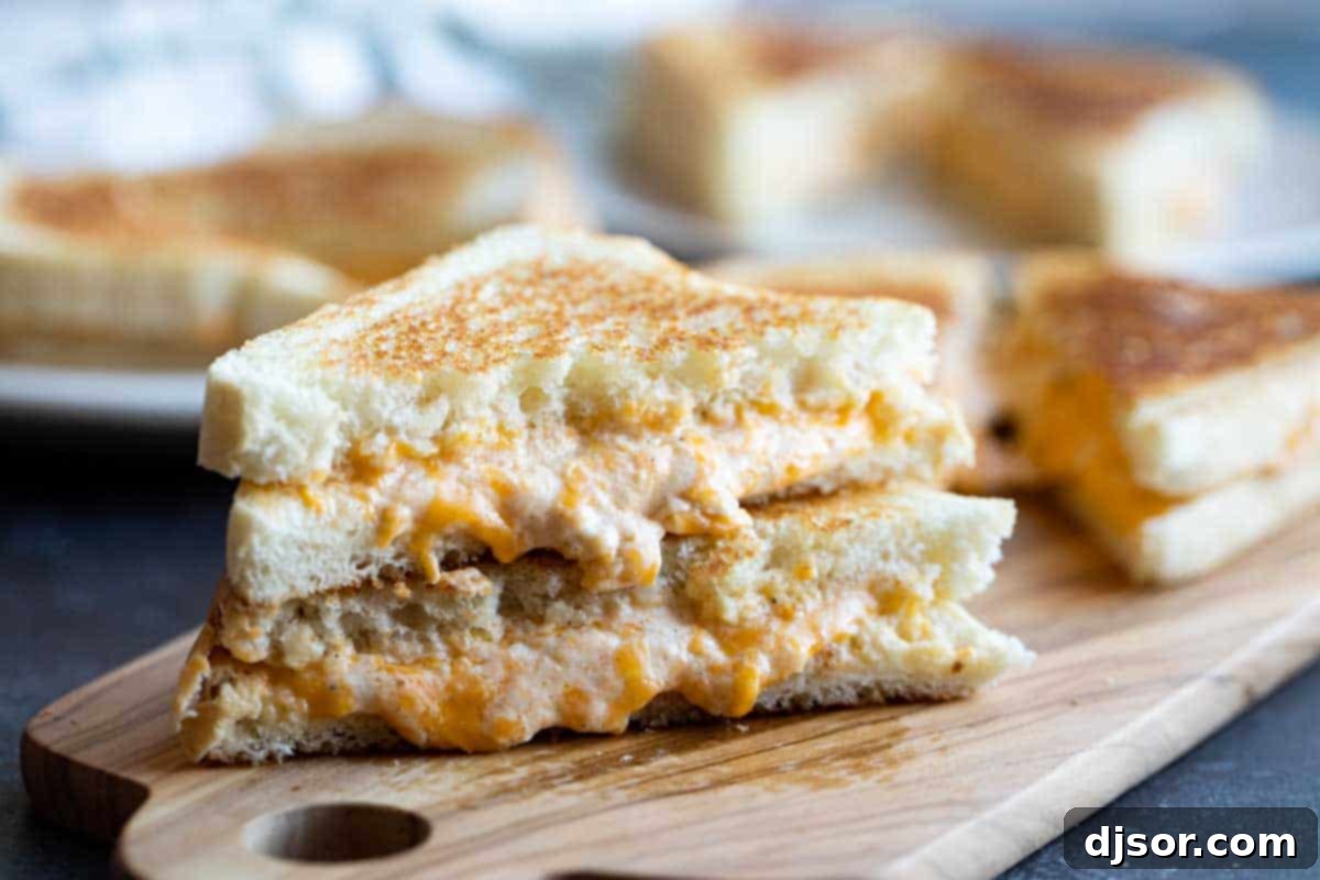 grilled cheese sandwich with halves stacked on each other, showing melted cheese