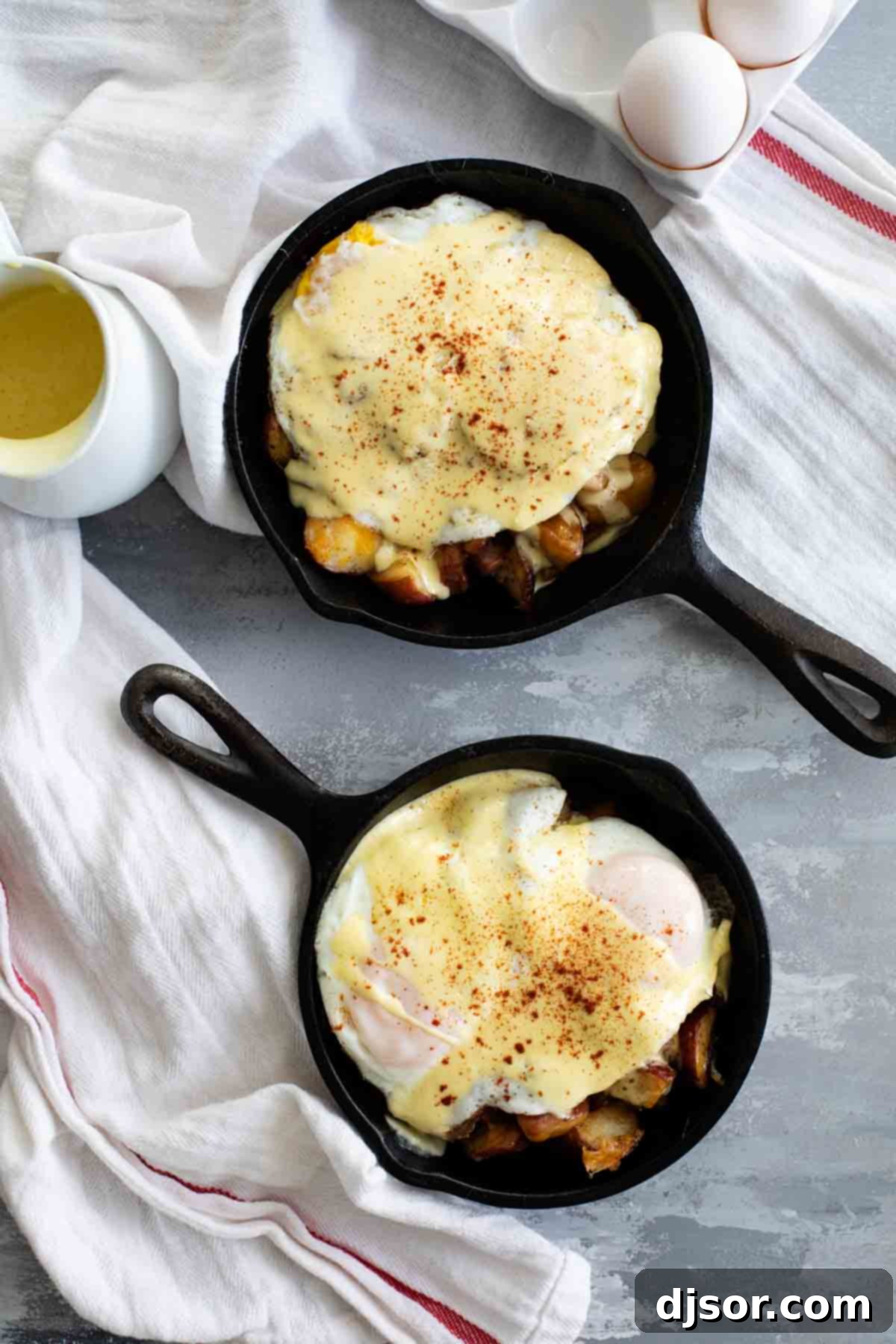 Meat and Potatoes Breakfast Skillet served in two cast iron skillets, highlighting the hearty ingredients.