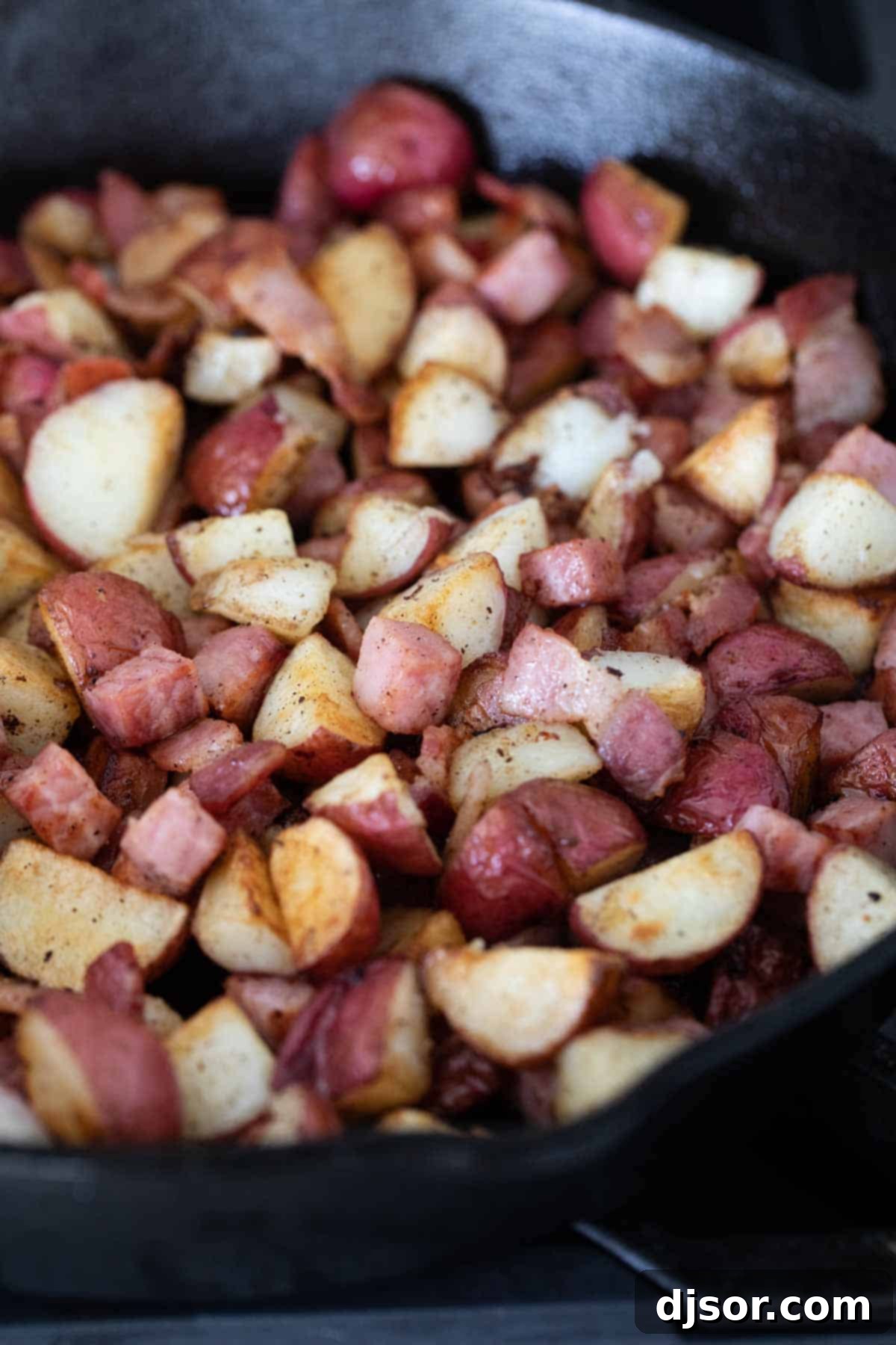 Diced potatoes, bacon, and ham ready for the Meat and Potatoes Breakfast Skillet.