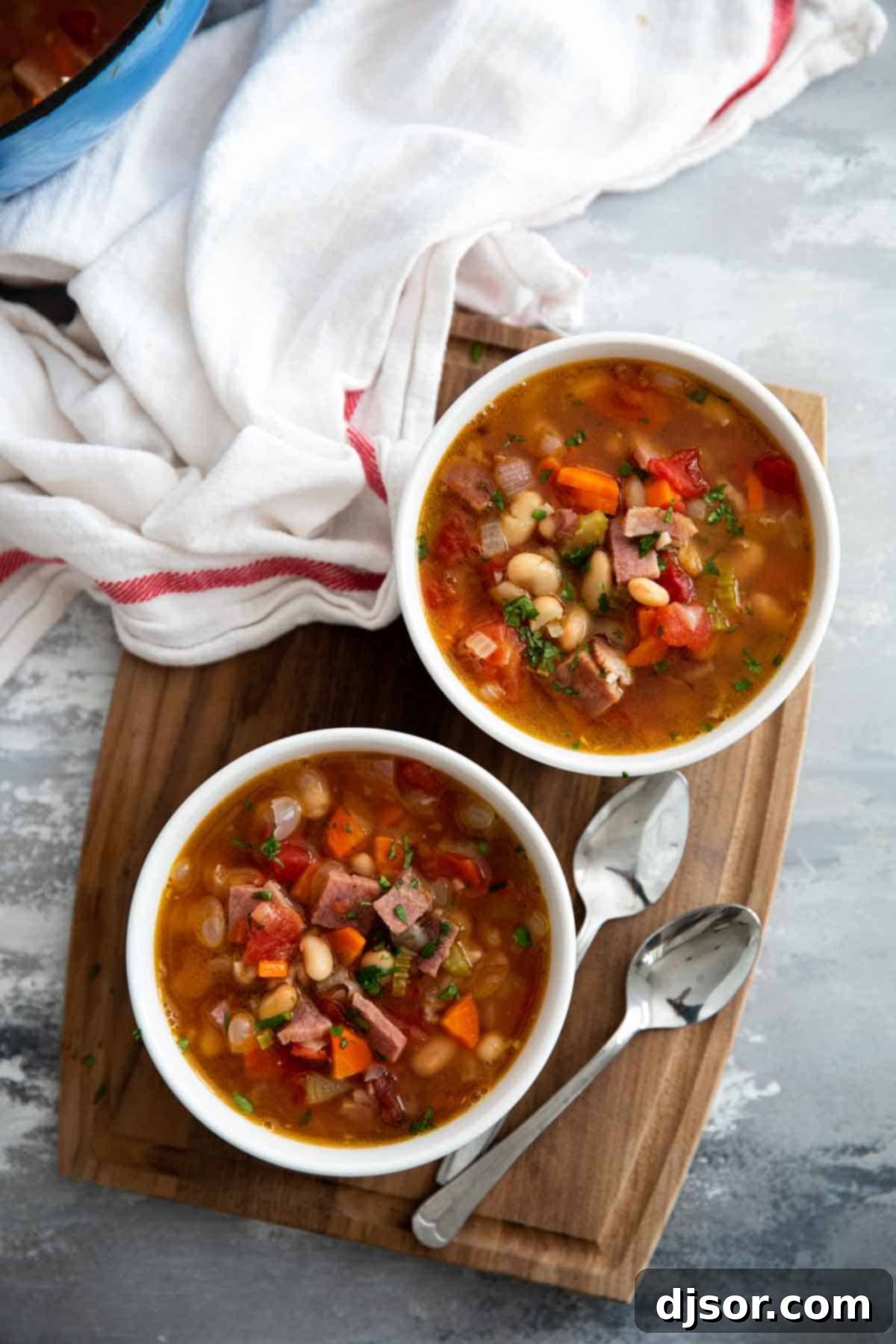 Easy Ham and Bean Soup, simmering to perfection on the stovetop. A pot of Ham and Bean Soup simmering on the stove, showing the delicious ingredients coming together.