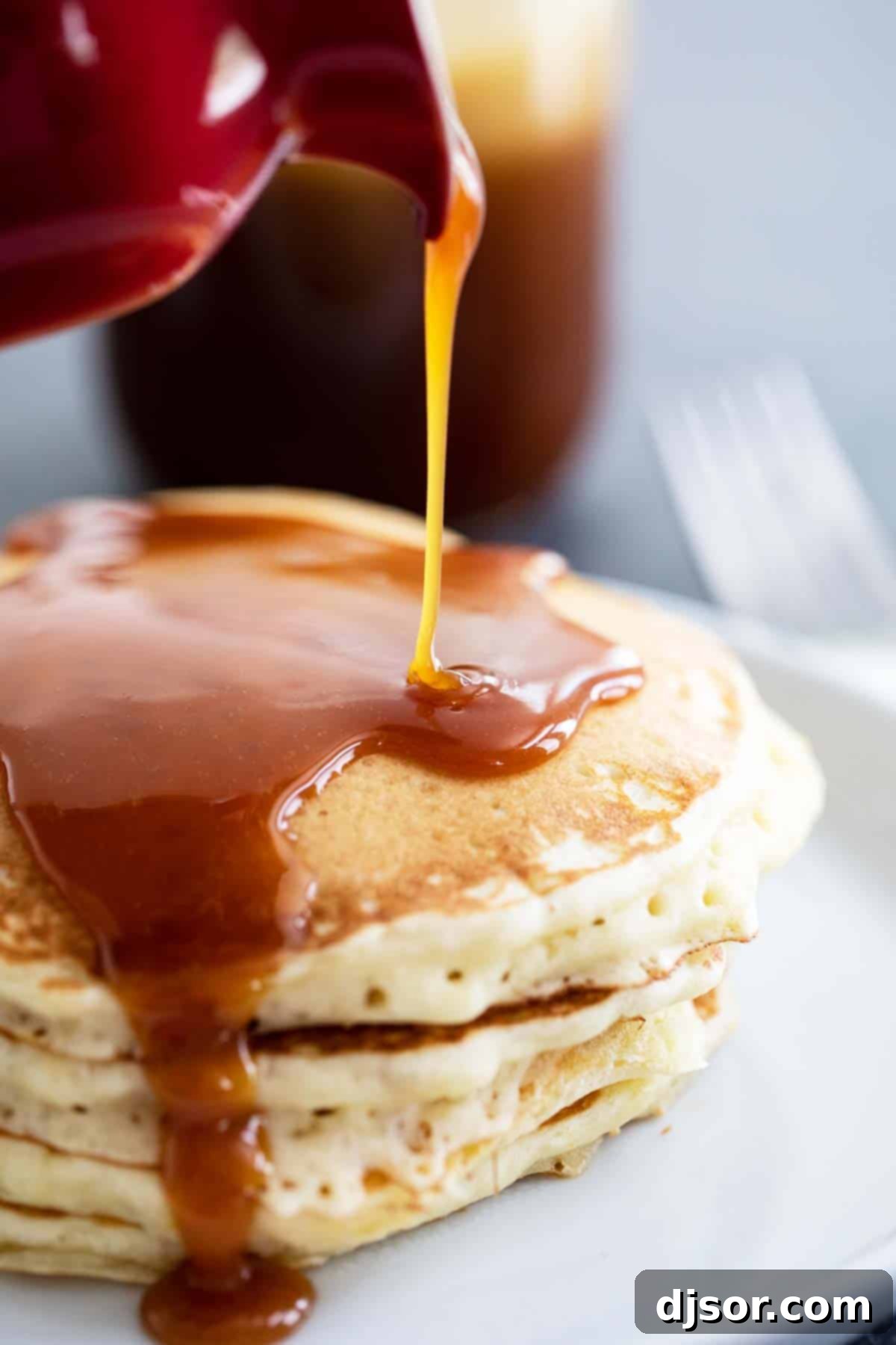 Homemade Syrup Recipe - Buttermilk Syrup poured generously over a stack of fluffy pancakes