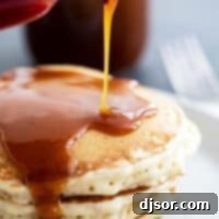 Homemade Buttermilk Syrup poured over a stack of pancakes