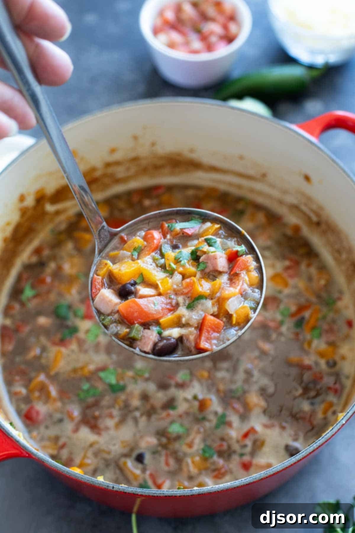 Ladle over a bowl of black bean and ham soup.