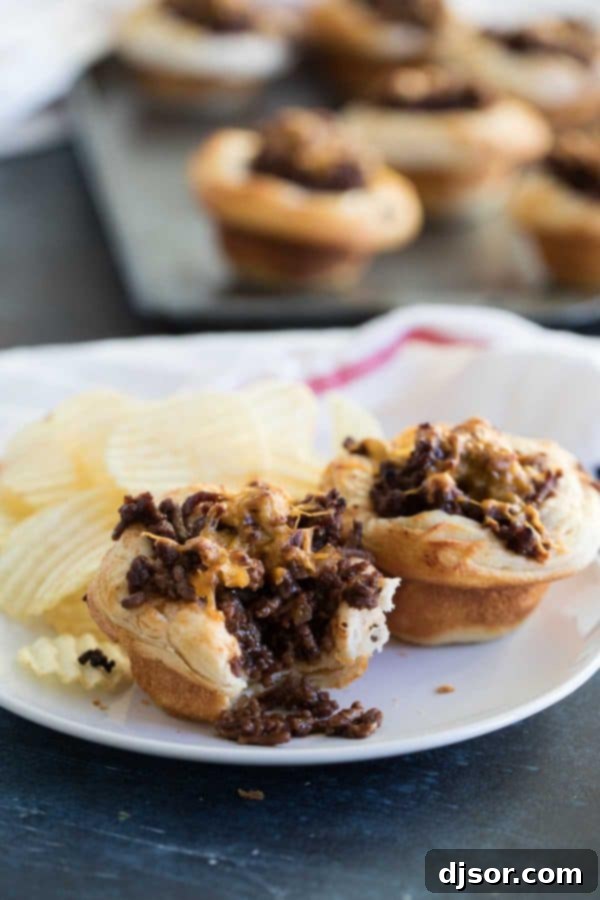 Dinner made easy - a ground beef and barbecue mixture is loaded into refrigerated biscuits and baked in these BBQ Beef Biscuit Cups. BBQ Beef Biscuit Cups on a plate