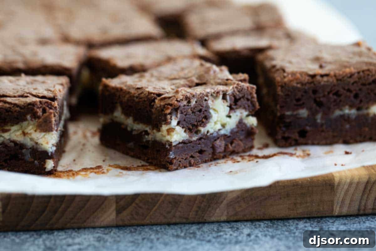Fudgy sliced coconut brownies revealing a creamy white coconut center, perfect for dessert lovers.