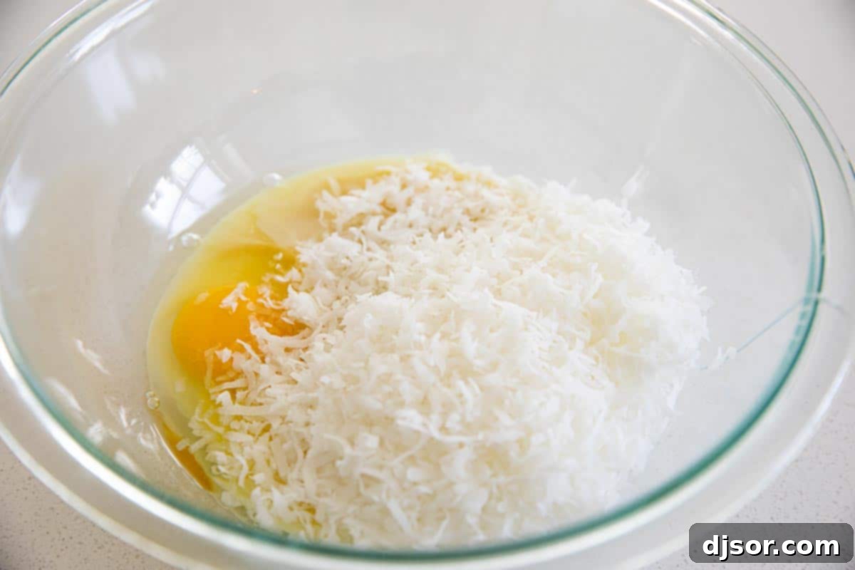 Creamy coconut filling mixture in a bowl, stirred and ready for layering in the brownies.