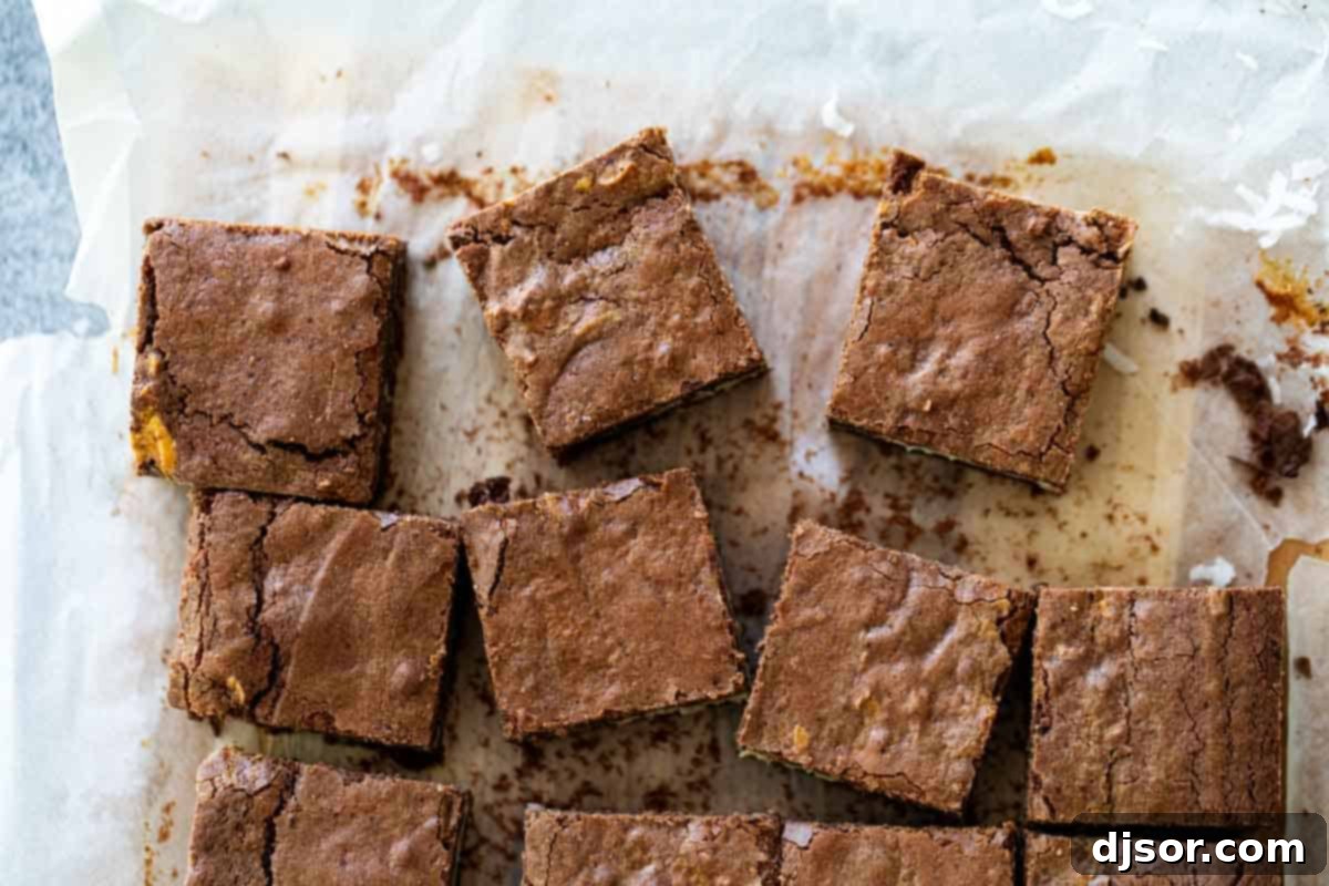 Overhead view of perfectly sliced coconut brownies with distinct layers of chocolate and white coconut.