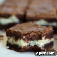 A close-up of a coconut brownie with a bite taken out, showcasing the fudgy chocolate and creamy coconut layers, tempting for dessert.