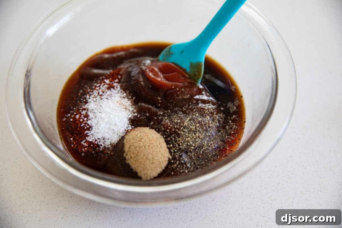glass bowl with ingredients for homemade bbq sauce being mixed