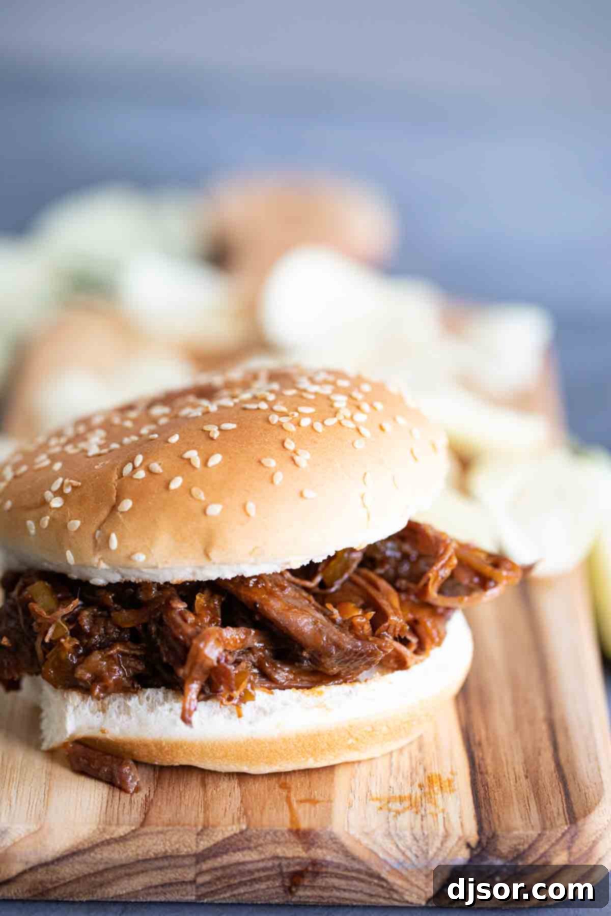 slow cooker bbq beef piled high on a hamburger bun