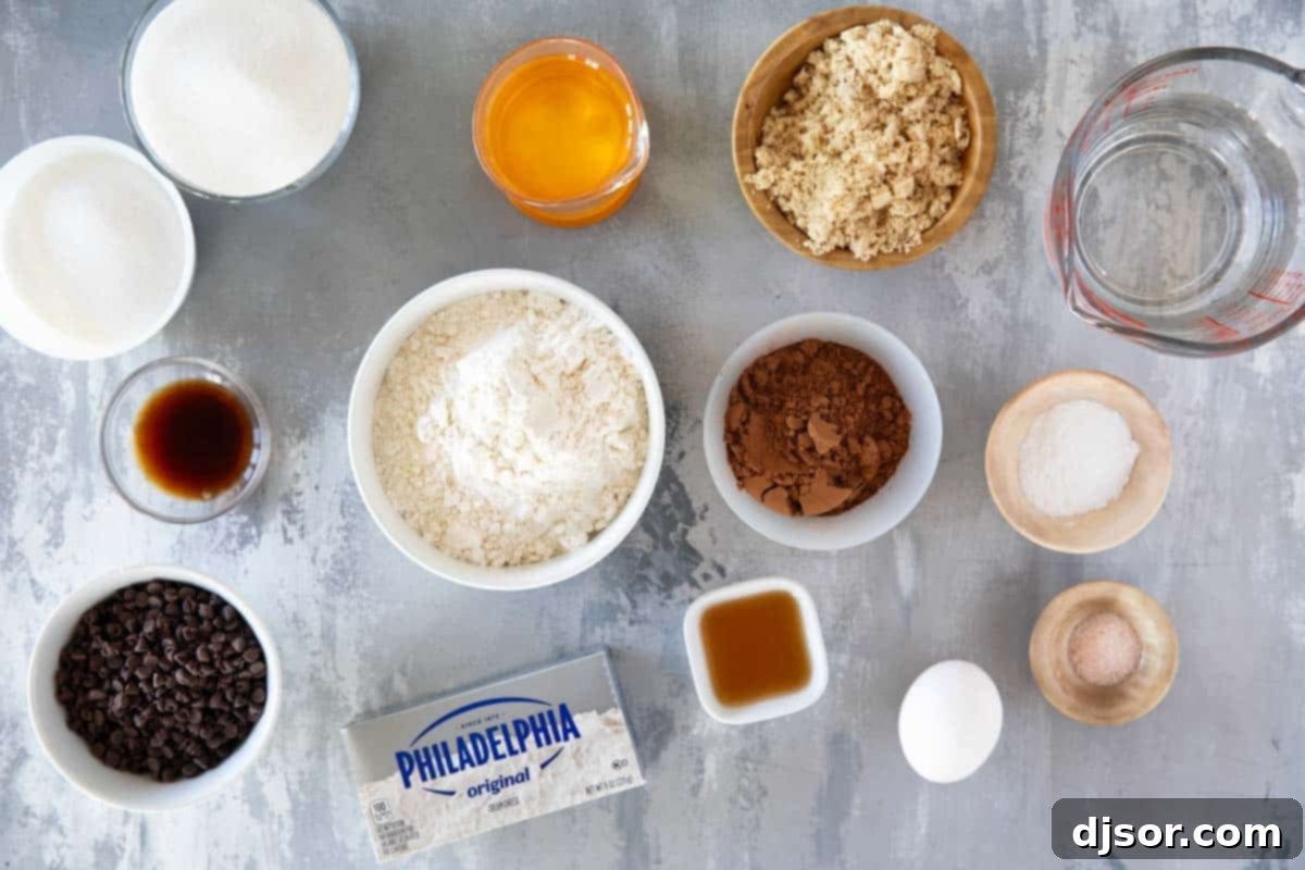 Assorted ingredients laid out for making Black Bottom Cupcakes, including cream cheese, flour, sugar, and cocoa powder.