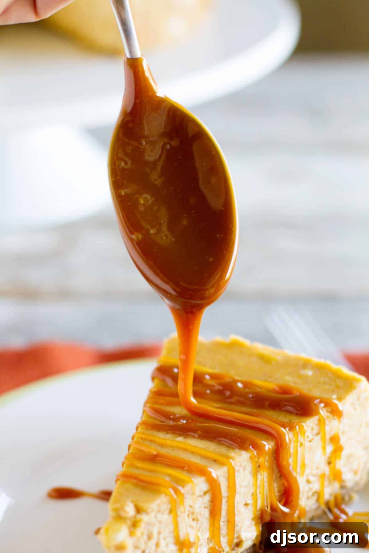 Decadent Homemade Caramel Sauce on Pumpkin Cheesecake Rich, homemade caramel sauce drizzled artfully over a creamy pumpkin cheesecake surface