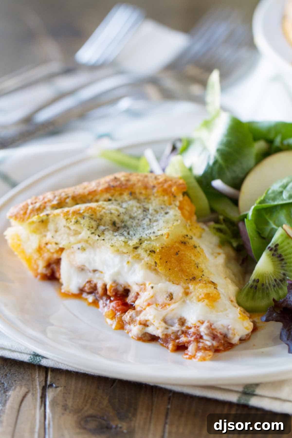 A single, delectable slice of Zesty Italian Crescent Casserole, ready to be enjoyed. slice of Zesty Italian Crescent Casserole