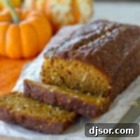 Loaf of pumpkin coconut bread with a few slices cut from it.