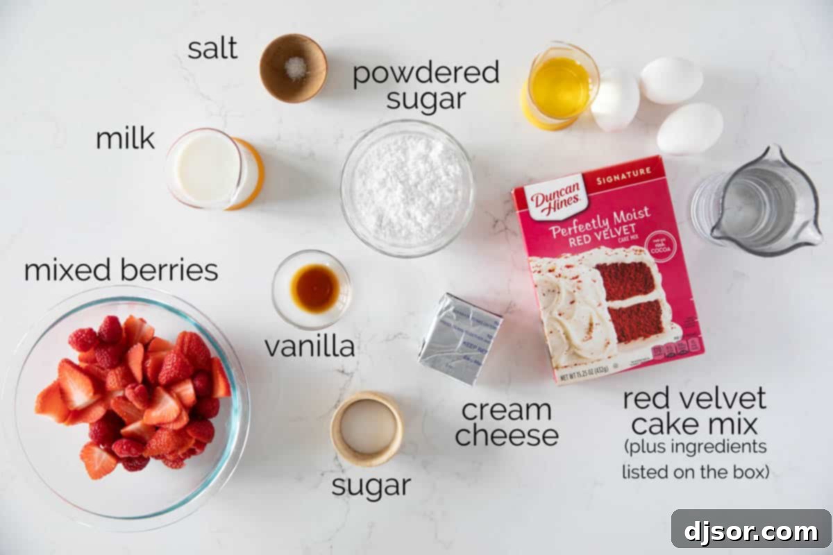 A flat lay photograph showcasing all the fresh ingredients required to make red velvet waffles and the cream cheese drizzle, including a box of cake mix, berries, sugar, cream cheese, powdered sugar, vanilla, salt, and milk.