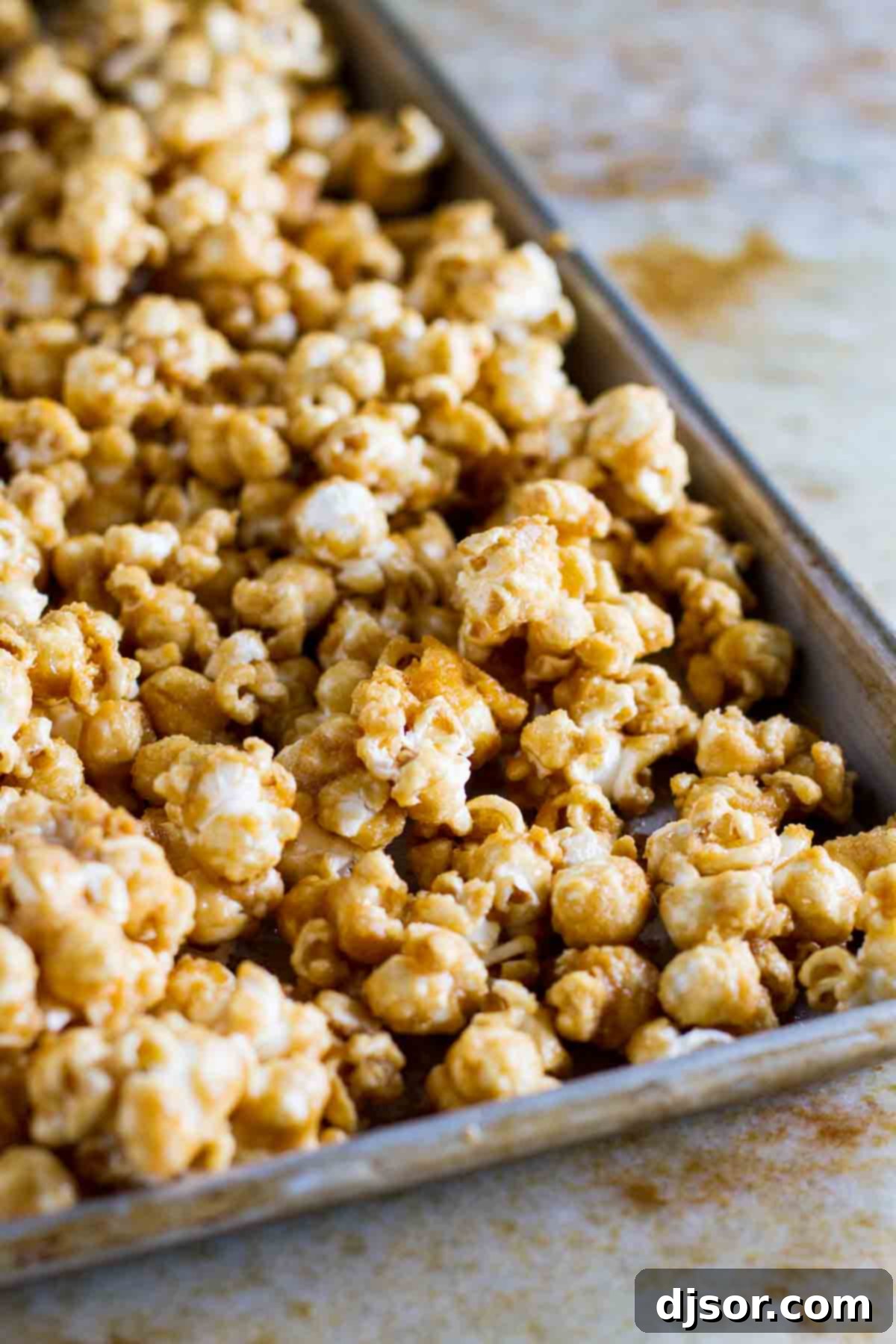 Golden Caramel Crunch Popcorn 3 Baked Caramel Popcorn on a baking sheet, glistening with caramel