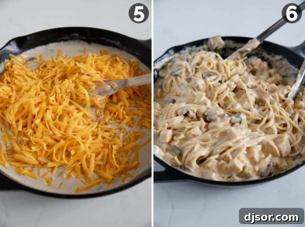Shredded cheddar cheese being added to the creamy sauce and stirred until melted.