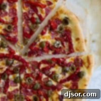 Loaded Antipasto Pizza 2 Full Antipasto Pizza cut into slices.