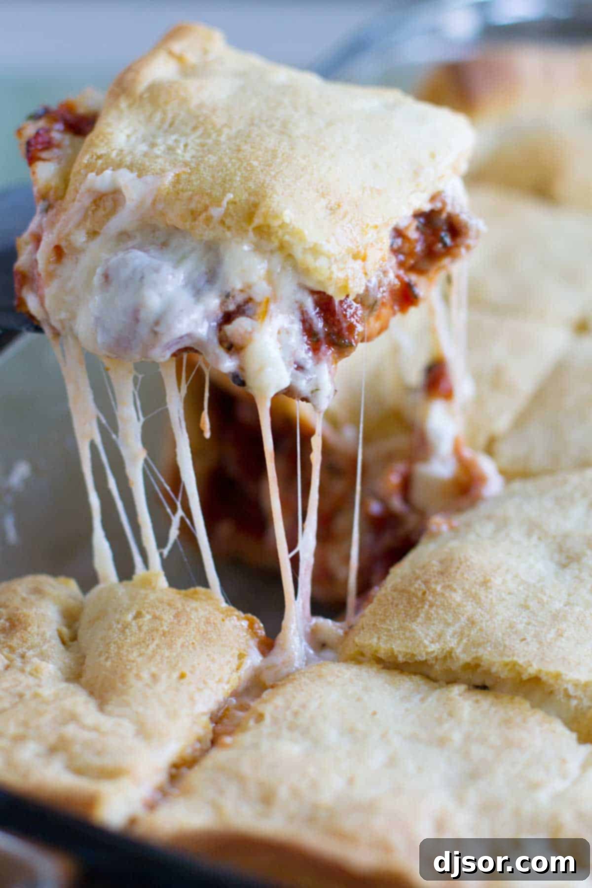 Scooping a slice of mock lasagna from a casserole dish.