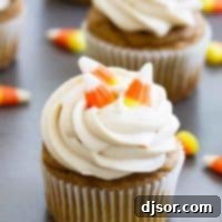Effortless Autumn Pumpkin Treats 4 Pumpkin cupcakes topped with brown sugar cream cheese frosting.
