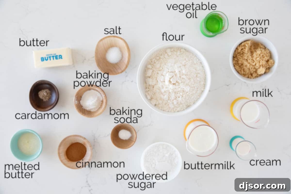A selection of essential ingredients laid out for making delicious cinnamon biscuits, including flour, butter, sugar, and spices.