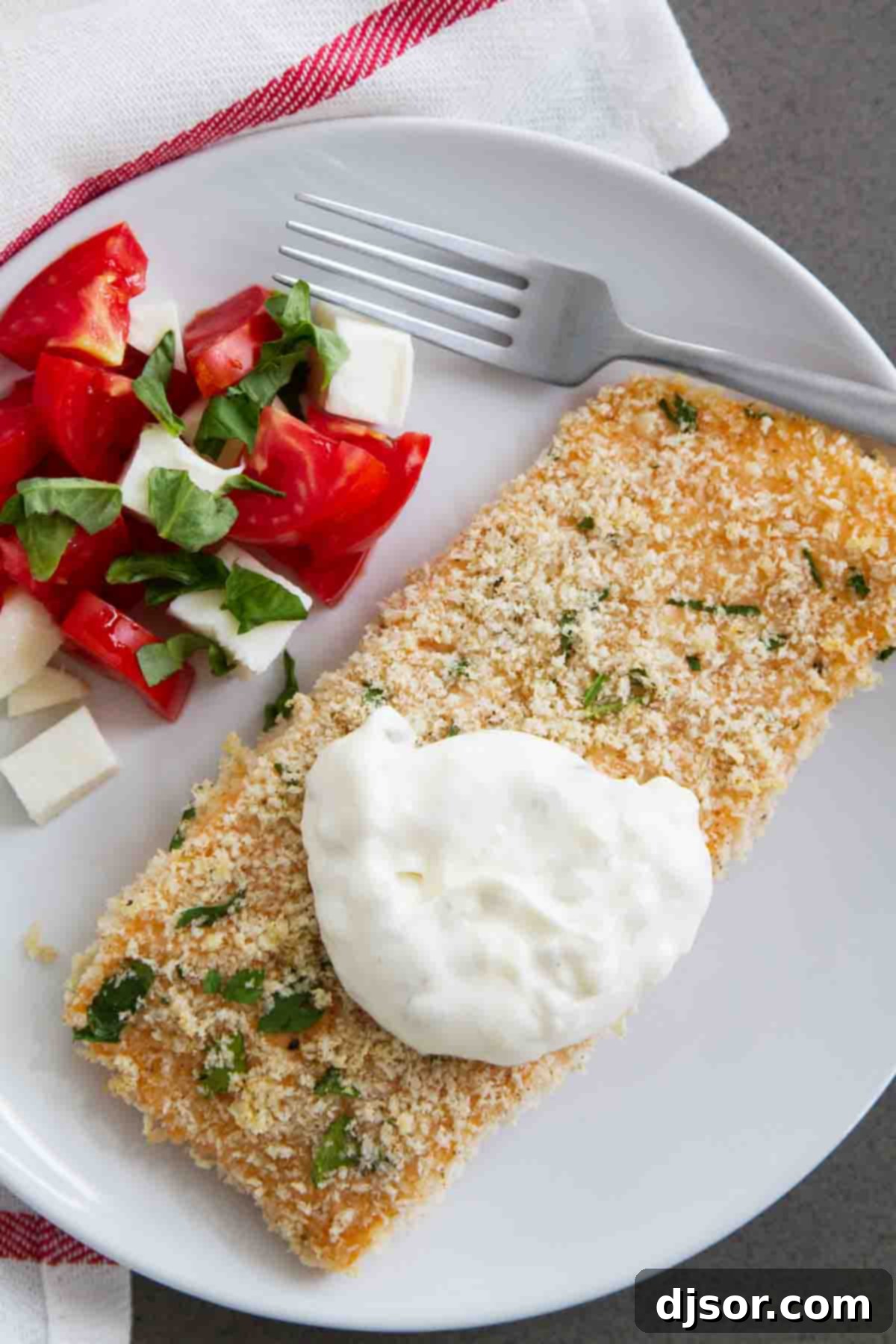 Baked Salmon Topped with Homemade Tartar Sauce, showcasing the golden crust and creamy sauce.
