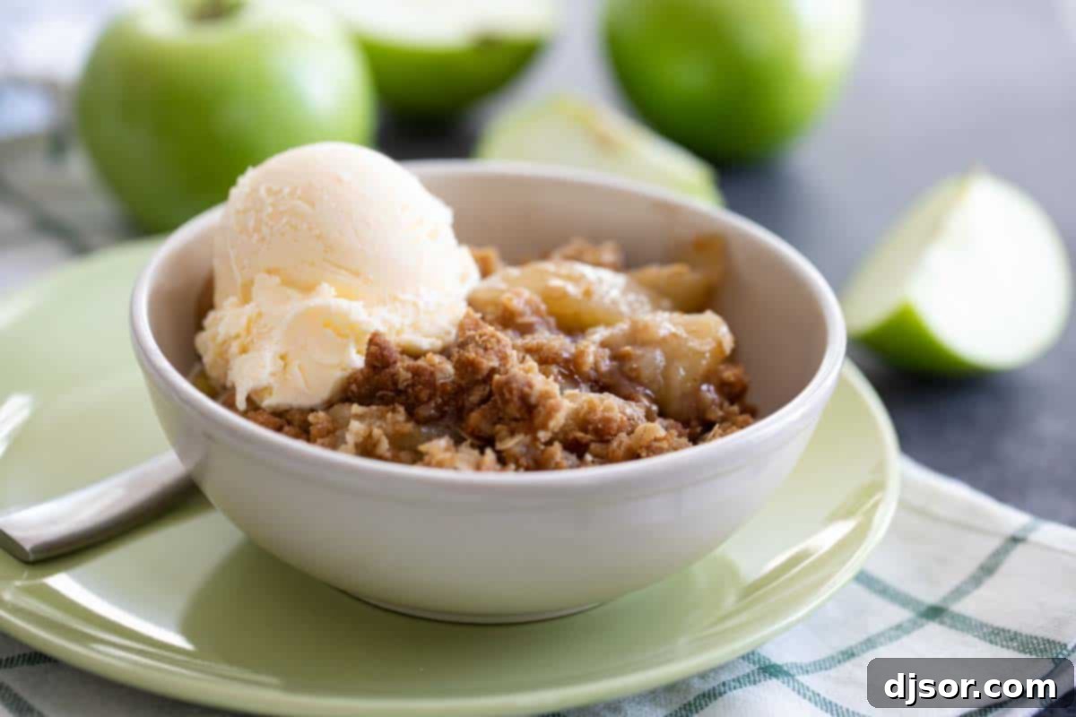 Classic Apple Crisp with Vanilla Ice Cream A comforting bowl of classic apple crisp with a melting scoop of vanilla ice cream, perfect for fall.