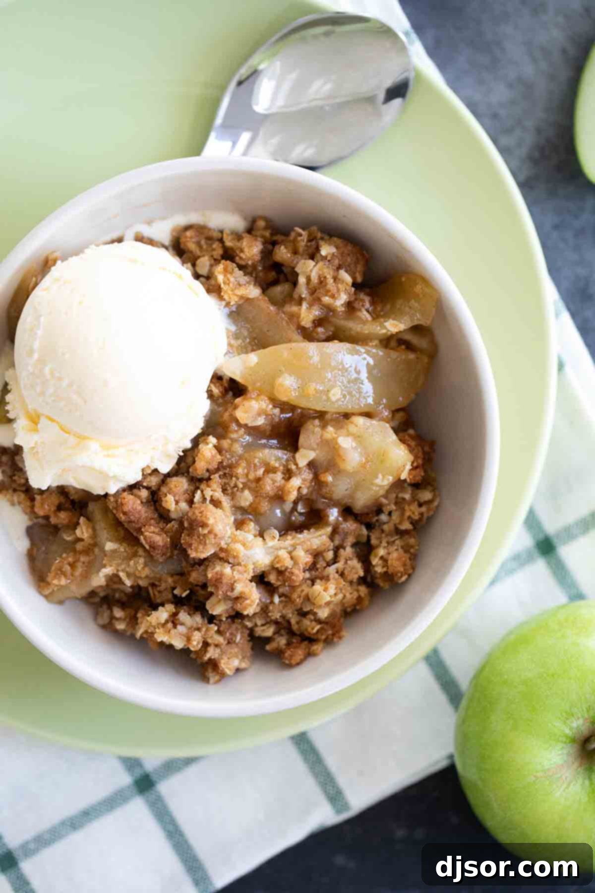 Overhead View of Apple Crisp with Ice Cream An inviting overhead view of a freshly baked apple crisp, garnished with a dollop of melting vanilla ice cream.