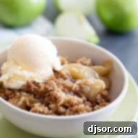 Perfect Apple Crisp 2 A beautifully presented bowl of apple crisp topped with a melting scoop of vanilla ice cream, ready to be enjoyed.