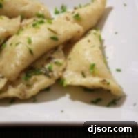 Brown Butter Pierogi Delight 3 Round image of golden-brown pierogi with brown butter sauce on a plate