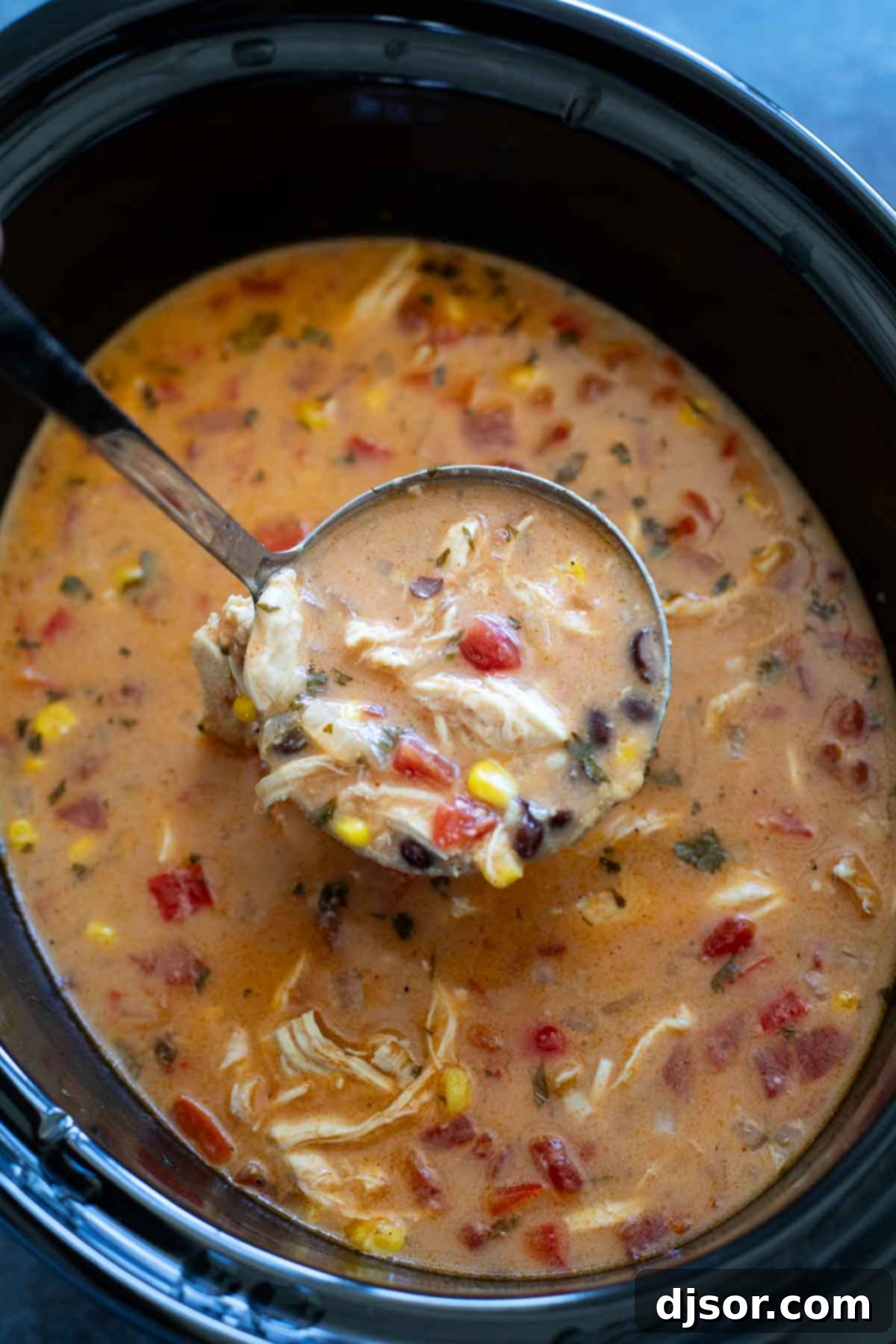 Cheesy Slow Cooker Chicken Enchilada Soup 7 Slow cooker filled with chicken enchilada soup.